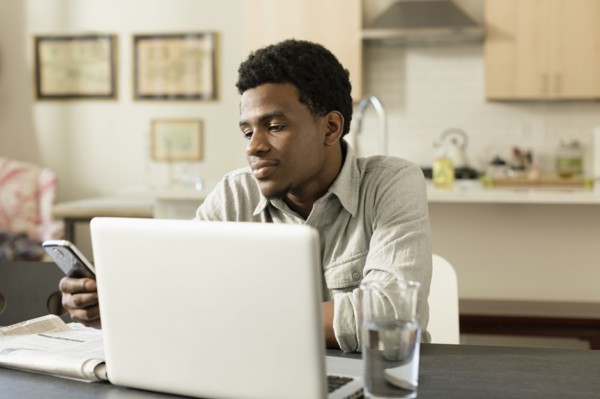 Black businessman working at breakfast table
