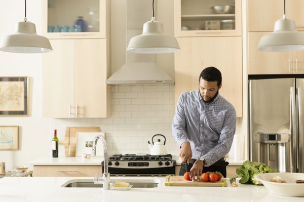 Mixed race man cooking in kitchen