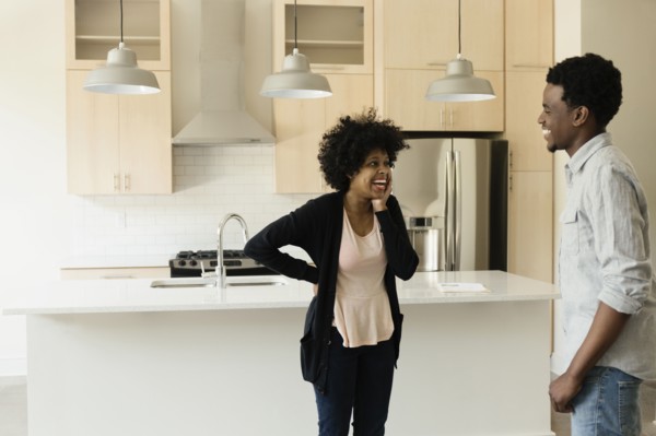 Couple talking in kitchen in new house