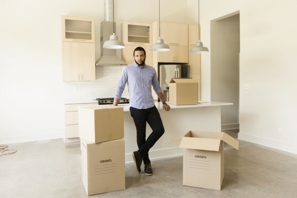 Mixed race man standing in new house