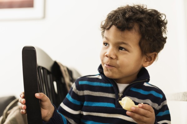 Mixed race boy eating at counter