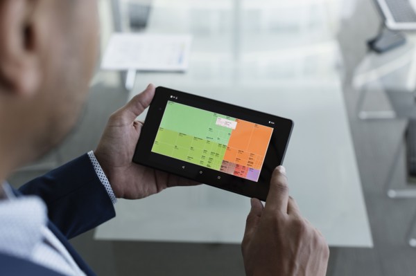 Hispanic businessman viewing graph on digital tablet