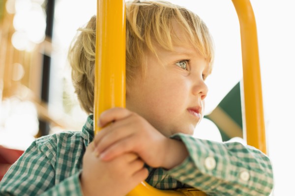 Caucasian boy on play structure in playground