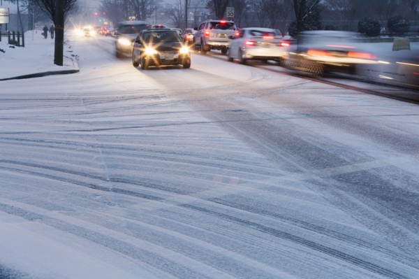 Traffic driving on snowy street
