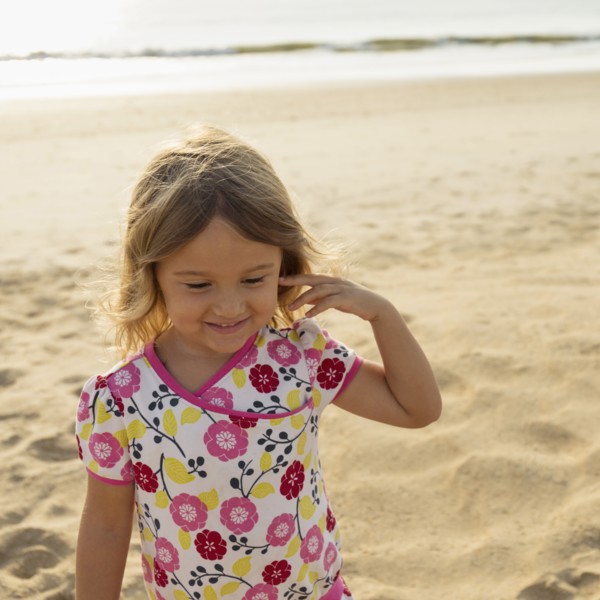 Mixed race girl smiling on beach