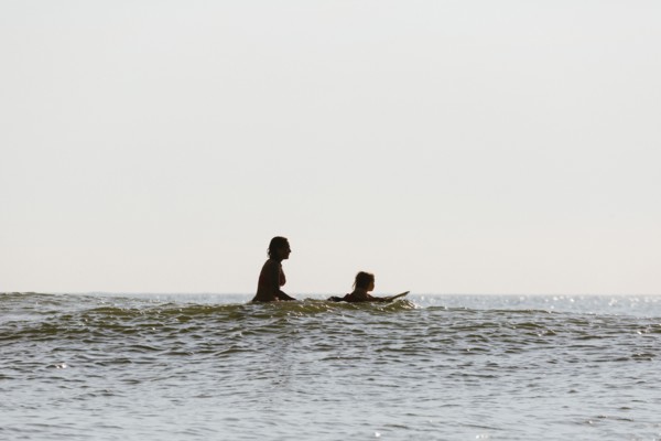 Mother and daughter surfing in waves