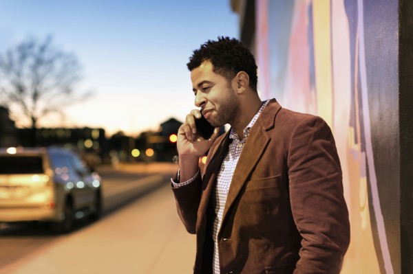 African American businessman talking on cell phone outdoors