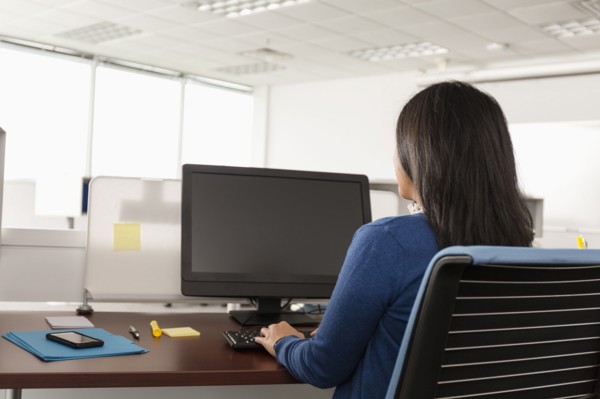 Pacific Islander woman using computer in office