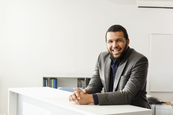 Mixed Race man smiling in office