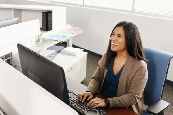 Pacific Islander woman using computer in office