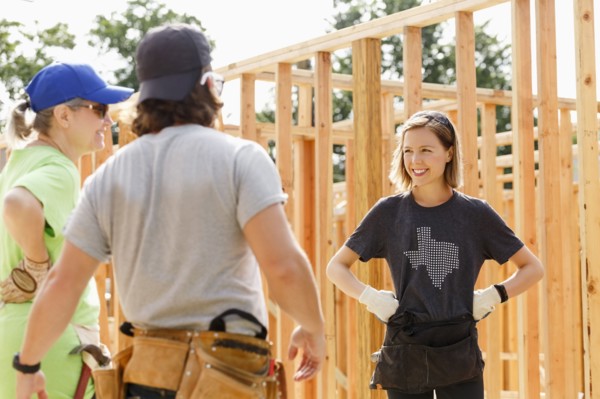 Caucasian volunteers standing at construction site
