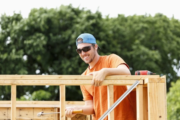 Caucasian man hammering at construction site