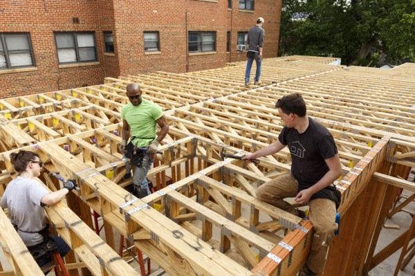 Volunteers hammering at construction site