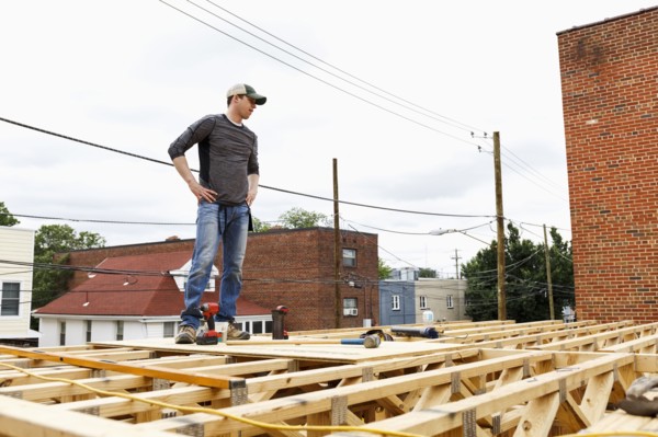 Caucasian man standing on the roof construction site