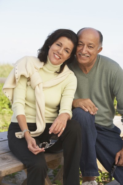 Senior couple hugging and smiling outdoors