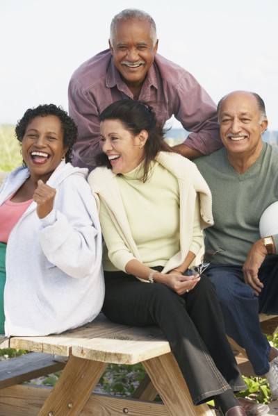 Two senior couples laughing outdoors