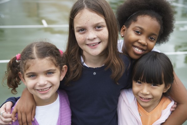 Multi-ethnic children hugging