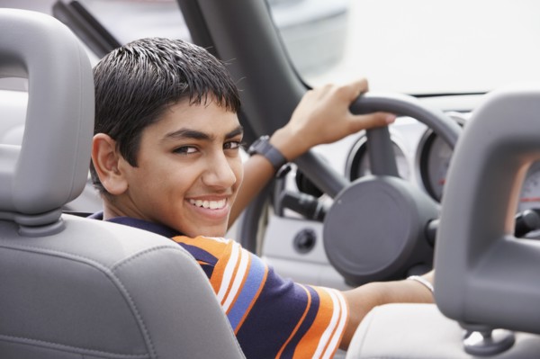 Middle Eastern teenaged boy in car