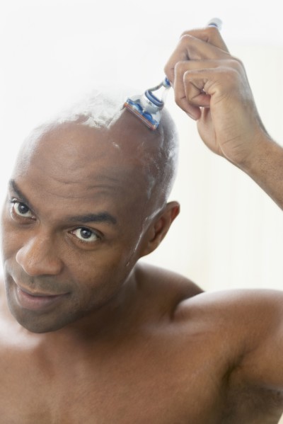 African American man shaving head
