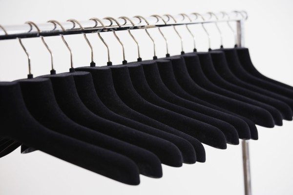 Row of empty clothing hangers on rack