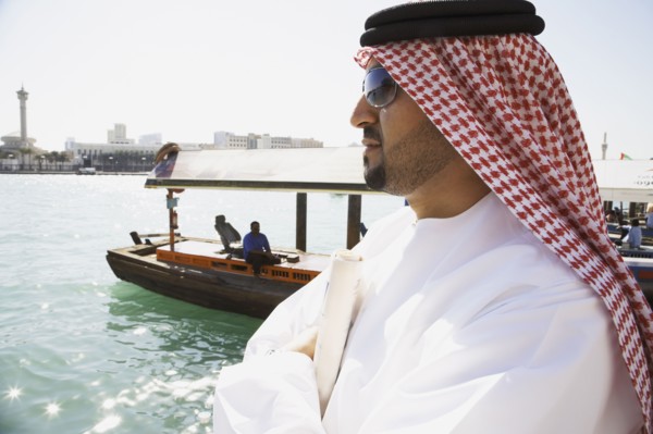 Arab man standing at waterfront