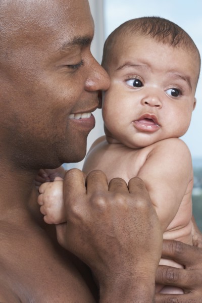 African father holding baby daughter