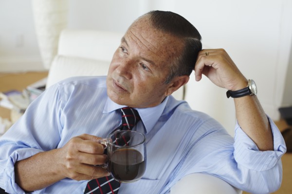 Hispanic businessman drinking coffee