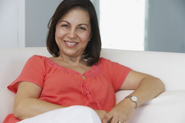 Hispanic woman relaxing on sofa