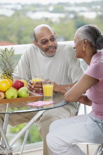 African couple drinking orange juice