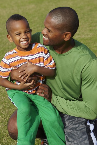 African American father holding son on lap