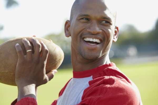 African American man throwing football