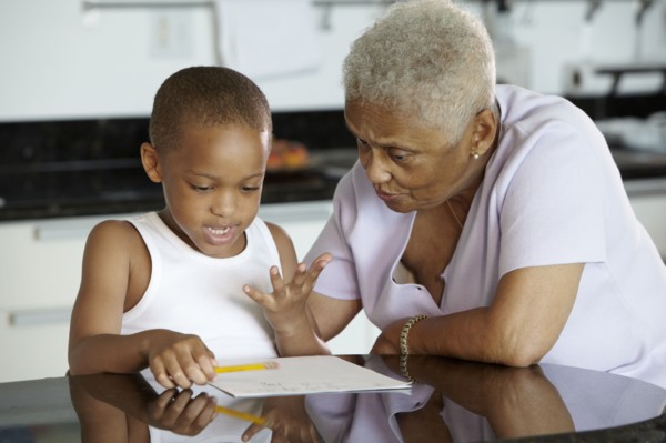 African American grandmother helping grandson with homework