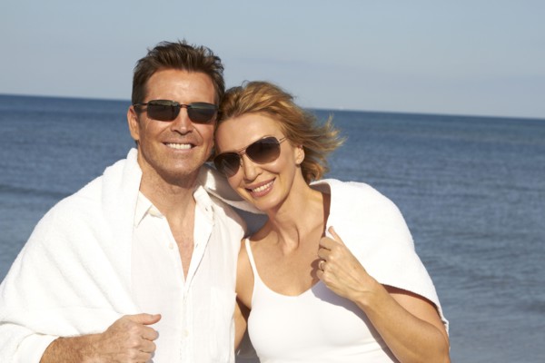 Caucasian couple smiling on beach
