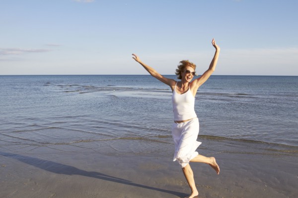 Caucasian woman playing on beach