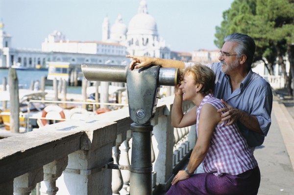 Senior couple looking through telescope