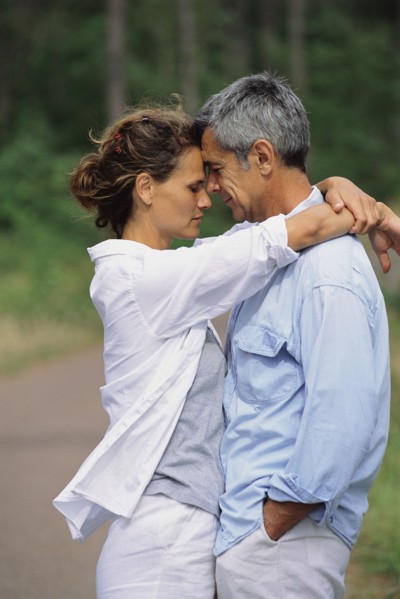 Caucasian couple hugging in park