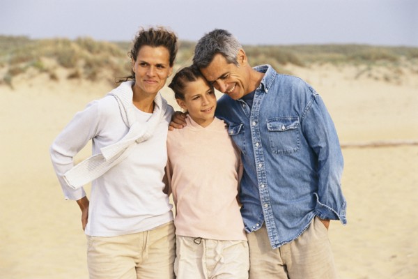 Caucasian family hugging on beach