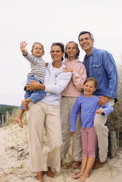 Caucasian family smiling on beach