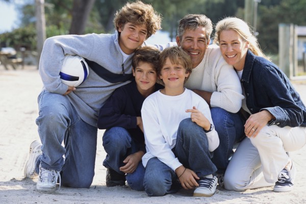 Family smiling together in park
