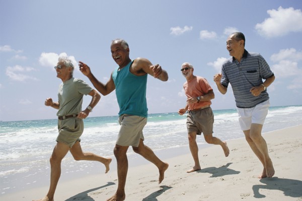 Senior couples jogging on beach