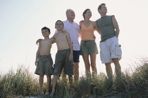 Family overlooking beach from hilltop