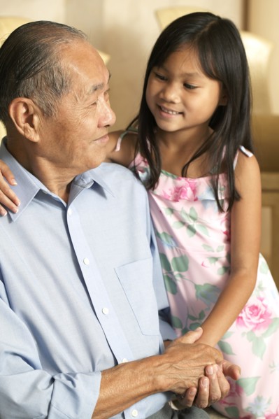 Senior man and granddaughter holding hands
