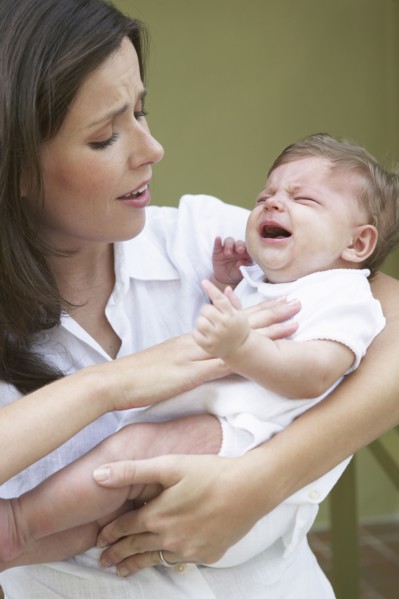Mother comforting crying baby