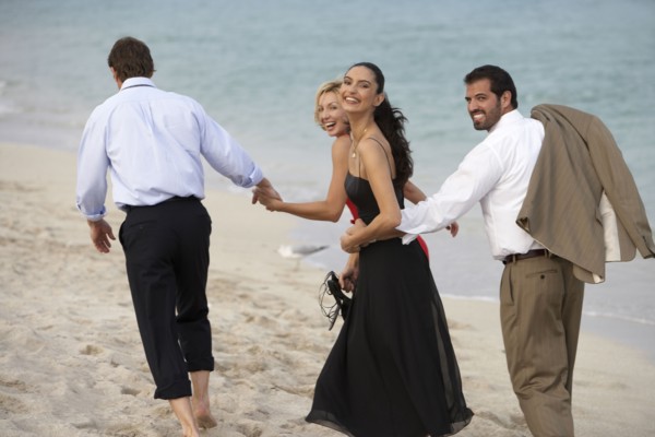 Couples walking together on beach