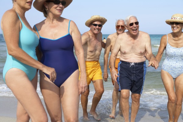 Senior friends relaxing on beach