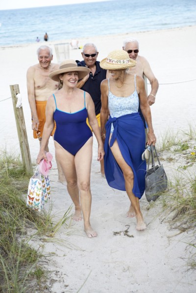 Senior friends walking on beach