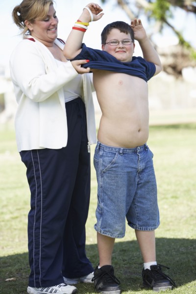 Mother helping son put on t-shirt
