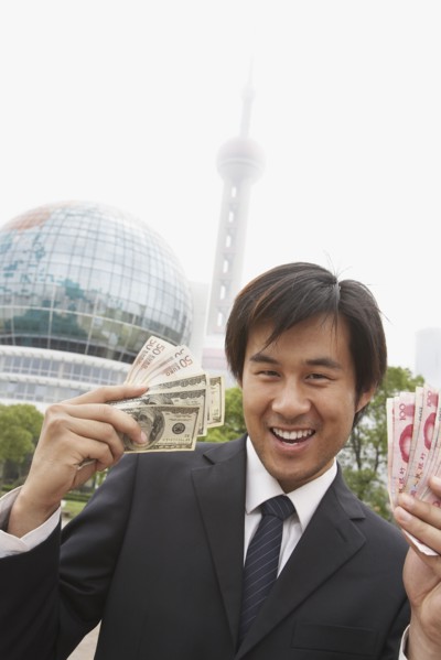 Chinese businessman holding wads of money