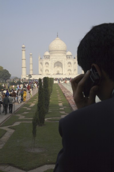 Indian businessman on cell phone by Taj Mahal
