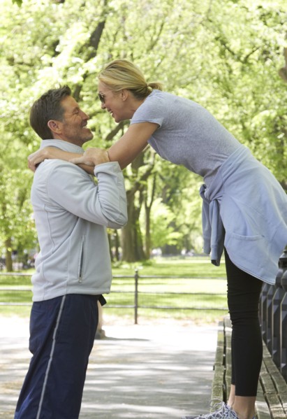 Caucasian couple playing in park